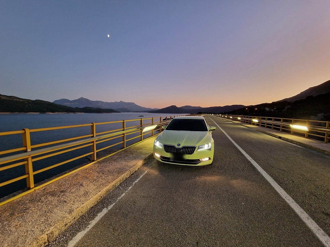 Taxi on a lake bridge at dusk